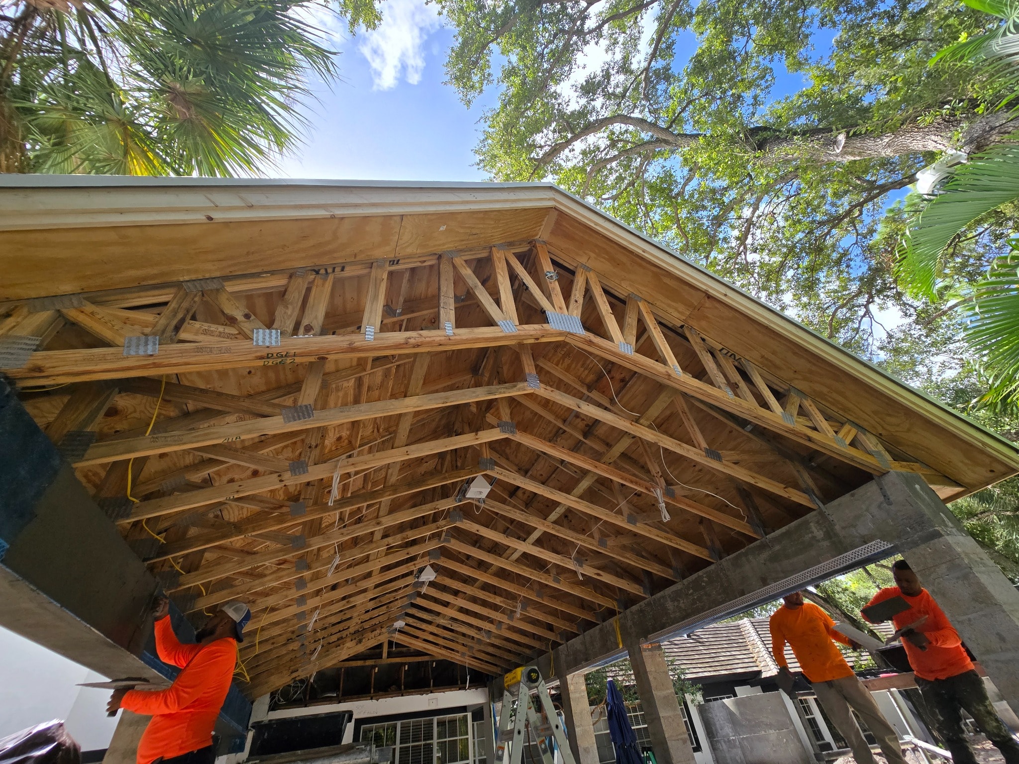 Covered patio roof framing under construction