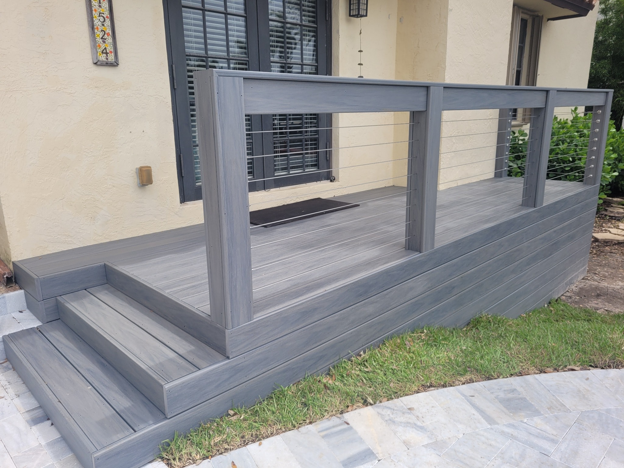 Gray composite entry deck with railing